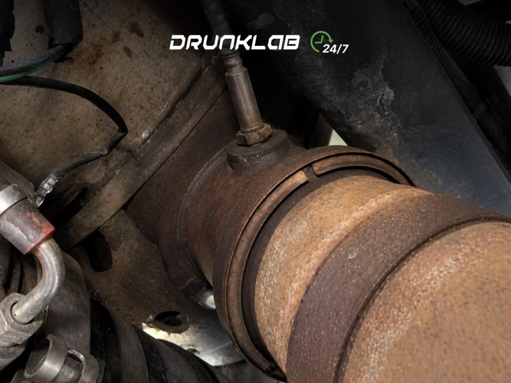 Rusty exhaust pipe with a NOx sensor mounted on top